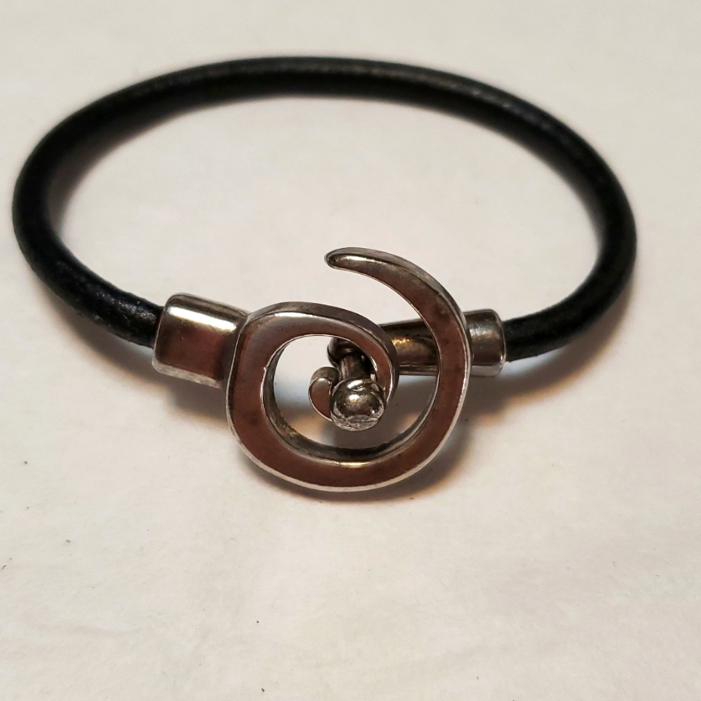 Silver leather bracelet.